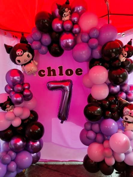 Kuromi balloon arch in pink, purple and black with a name and a number 7