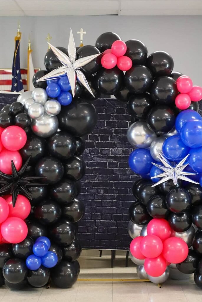Black, hot pink and blue balloon arch with silver star balloons for a rock theme 2nd birthday