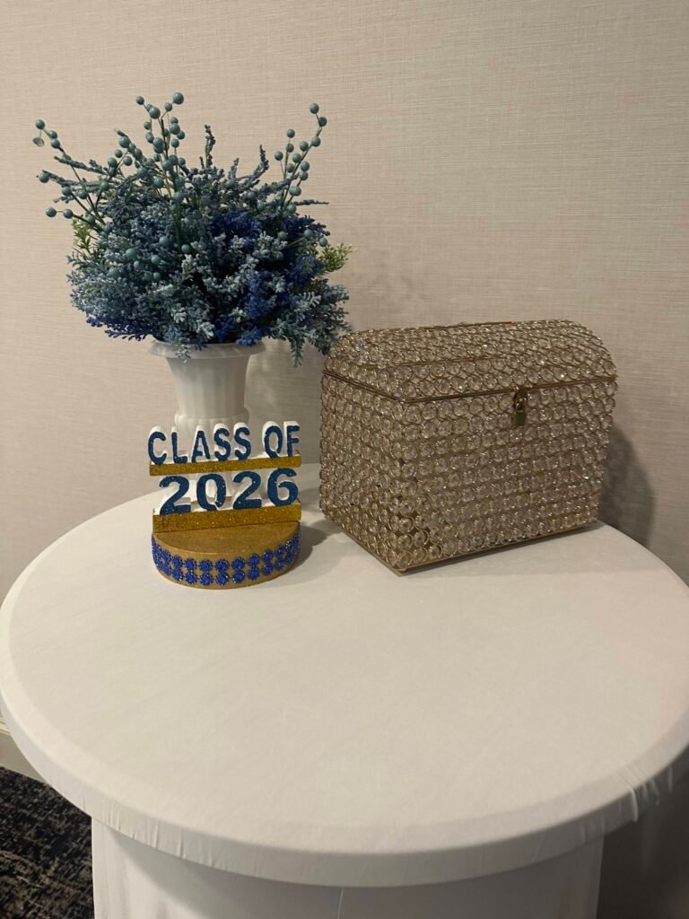 Class of 2026 centerpiece with blue flowers next to a woven card box