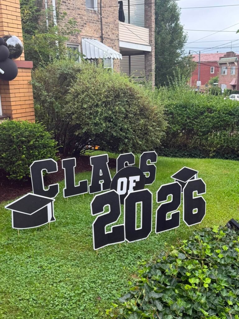 Class of 2026 yard sign on a green lawn
