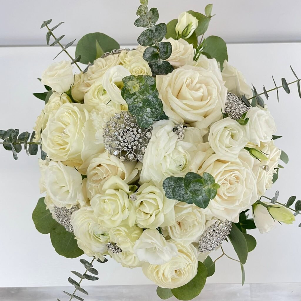 Round white rose bridal bouquet with eucalyptus and thistle