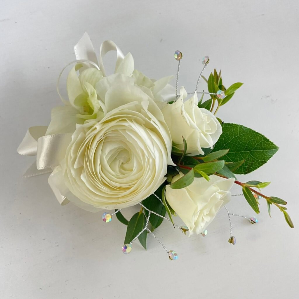 White rose boutonniere with greenery