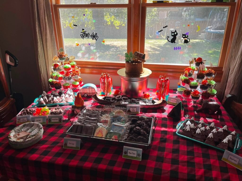 Long plaid table with trays of treats