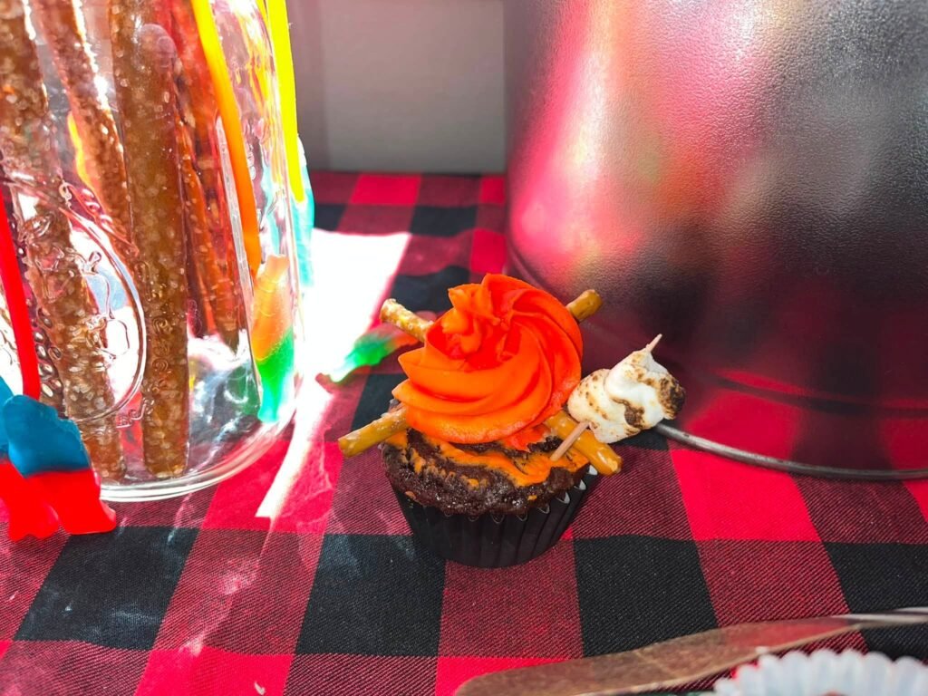 Campfire cupcake with flame frosting and pretzel logs