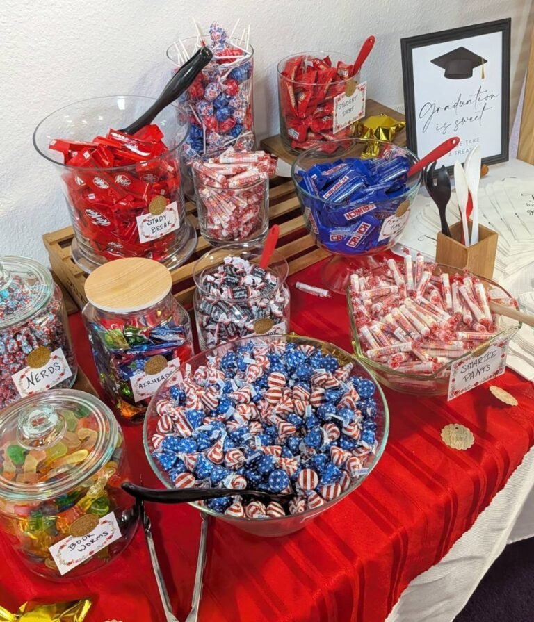 Graduation candy bar with jars of candy on a red tablecloth
