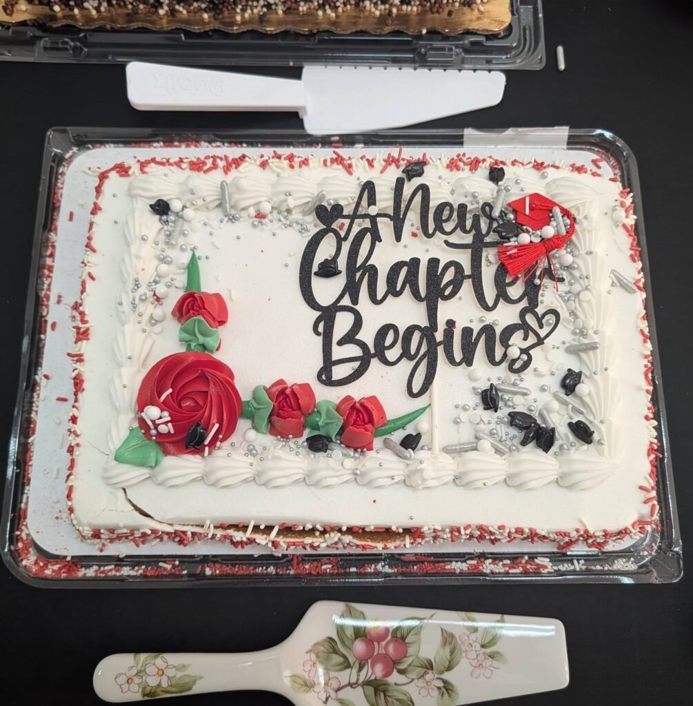 A New Chapter Begins graduation sheet cake with red roses
