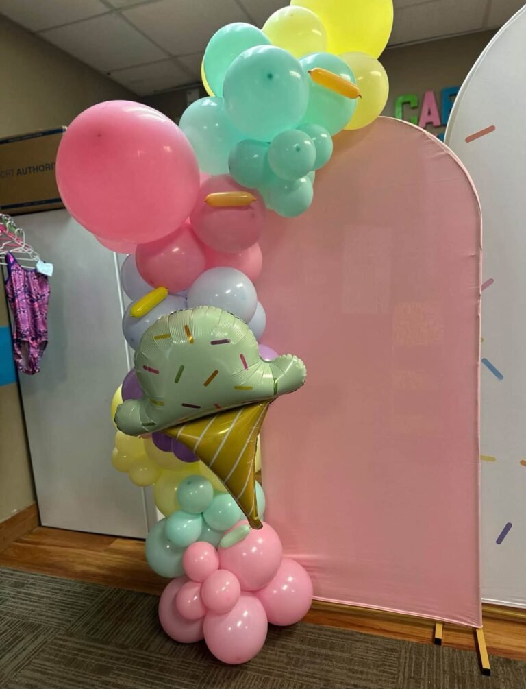 Ice cream cone balloon column next to a pink arch