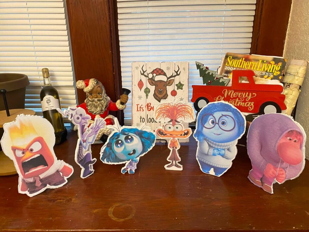 Row of small Inside Out character cutouts on a table