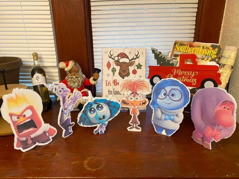 Row of small Inside Out character cutouts on a table