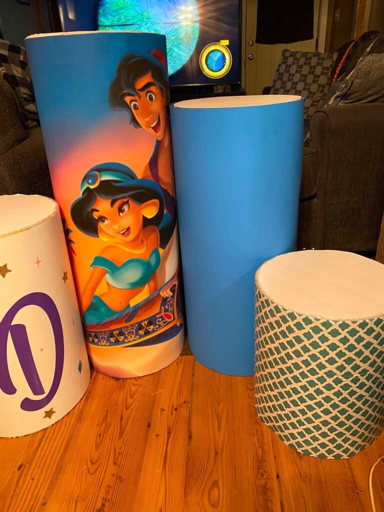 Printed cylinder plinths with Aladdin and Jasmine art