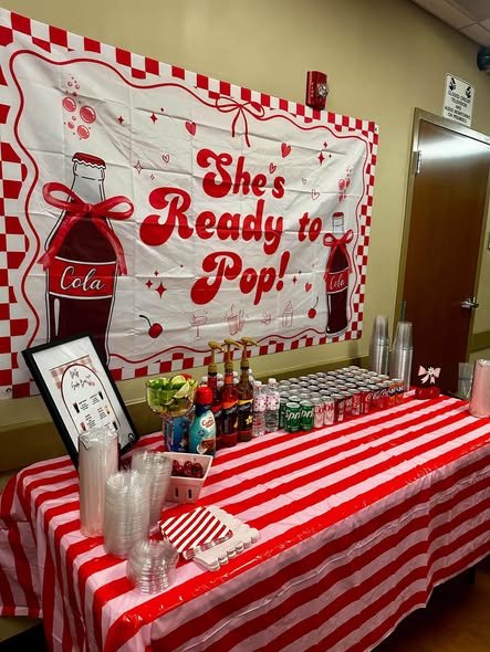 Ready to Pop banner over a drink table with glass soda bottles and a red striped cloth