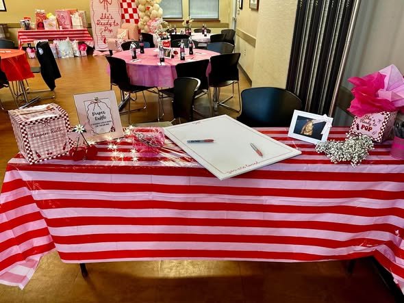 Red and white striped guest book table with a card box and photo frame