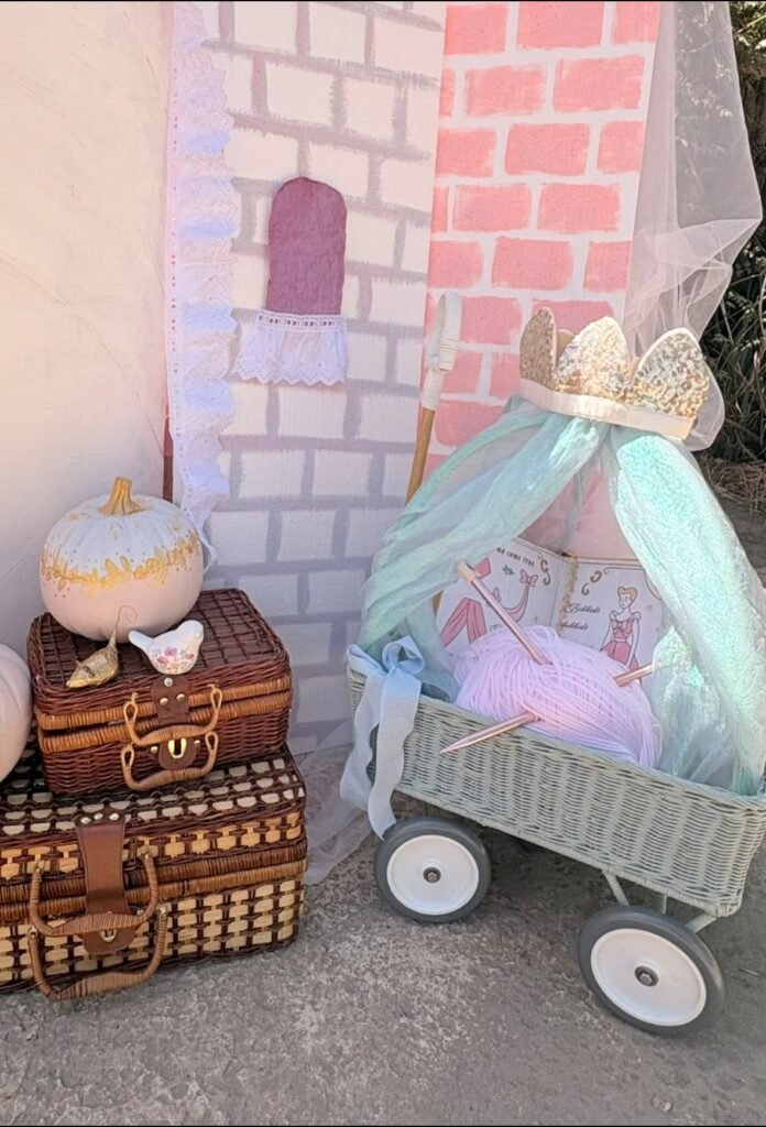 Pumpkin carriage wagon with a pink canopy, a pumpkin and vintage suitcases