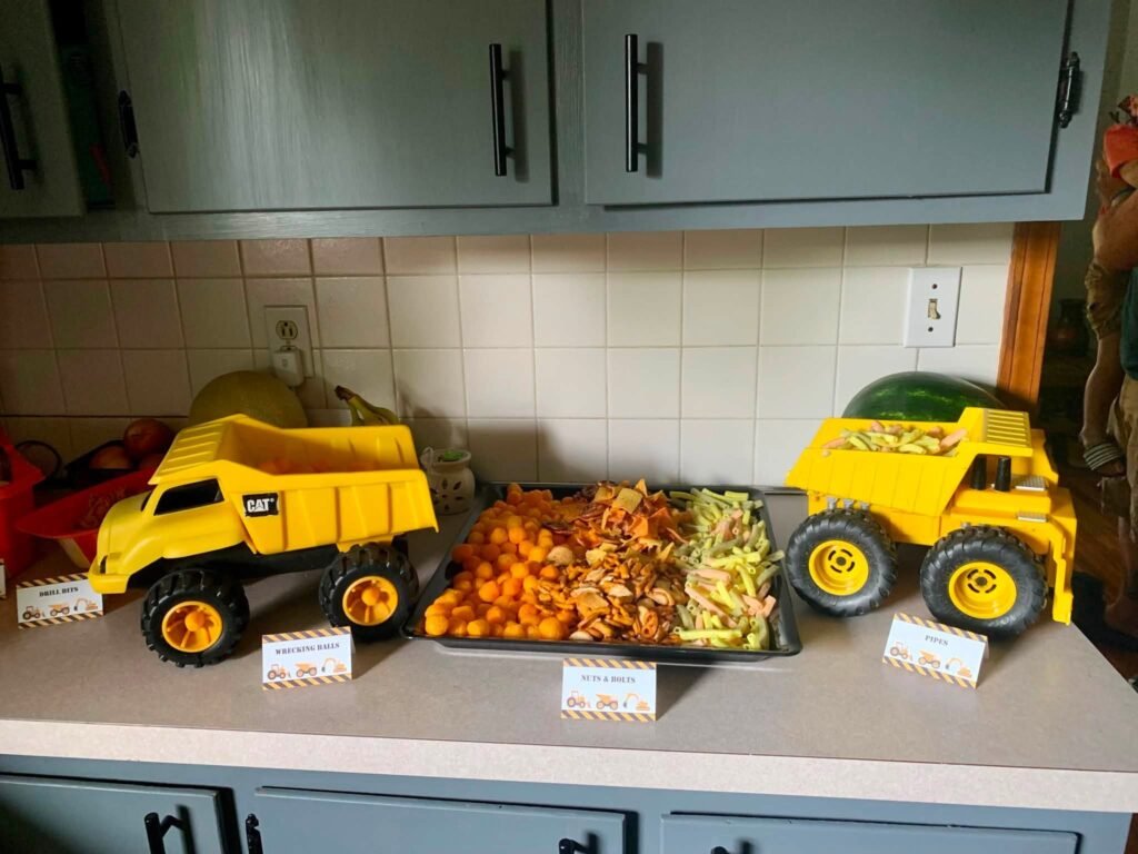 Toy dump trucks used as food trays on a kitchen counter