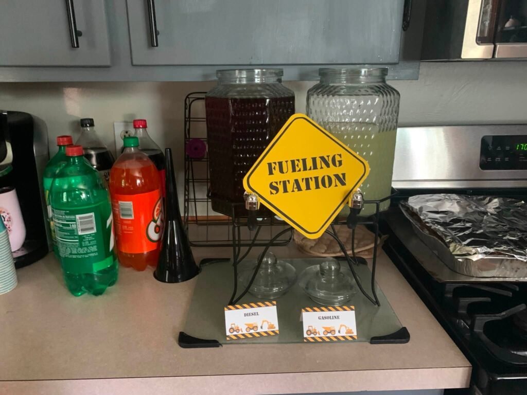 Fueling Station sign with soda bottles and a drink dispenser