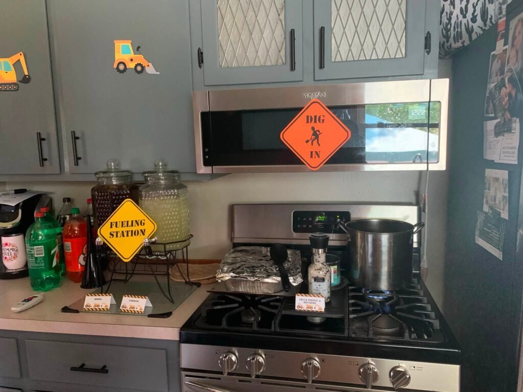 Kitchen decor with construction signs and a number 3 sign over the stove