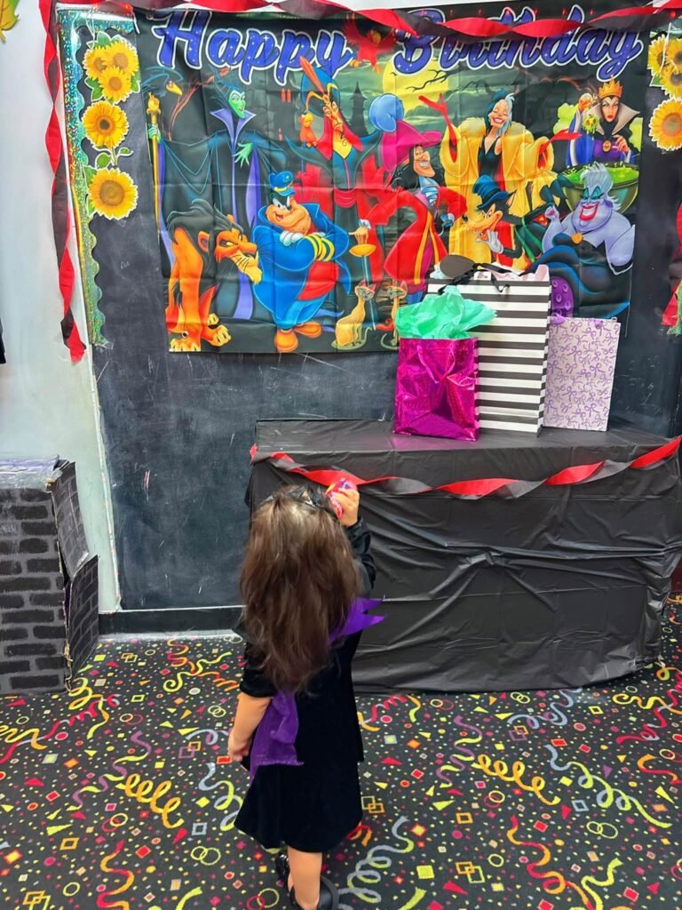 Villain backdrop with streamers and confetti on the floor