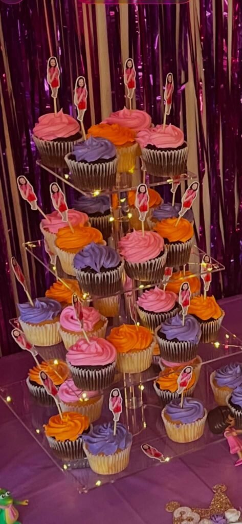 Tall cupcake tower with purple and orange frosting