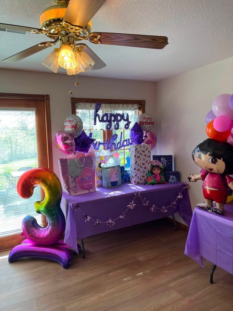 Room with a giant three balloon and Dora balloon