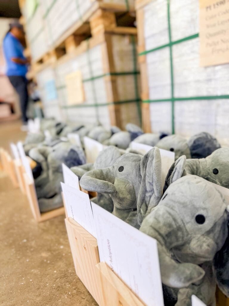 Row of plush elephant party favors with name tags
