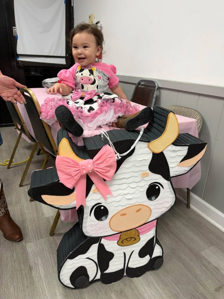 Little girl in a chair with a pink bow cow cutout