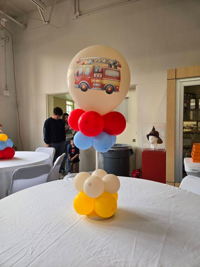 Balloon centerpiece with a fire truck picture balloon on top