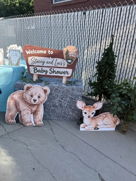 Woodland baby shower welcome sign with a bear and deer cutout