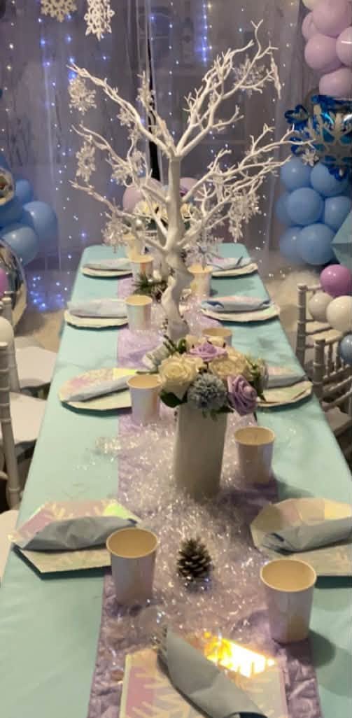 White branch tree centerpiece on a long winter wonderland table