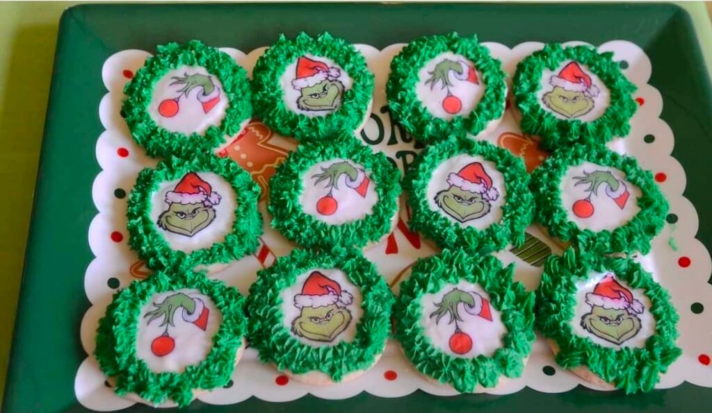 Tray of green Grinch cupcakes with red hearts