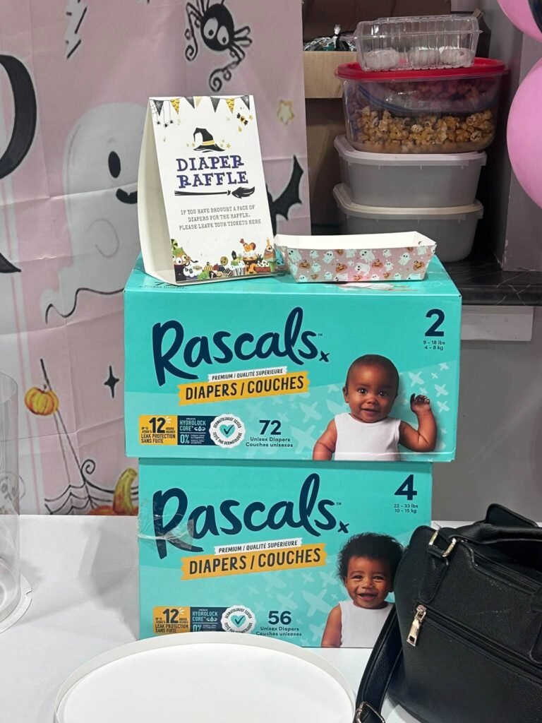Diaper raffle sign on stacked diaper boxes