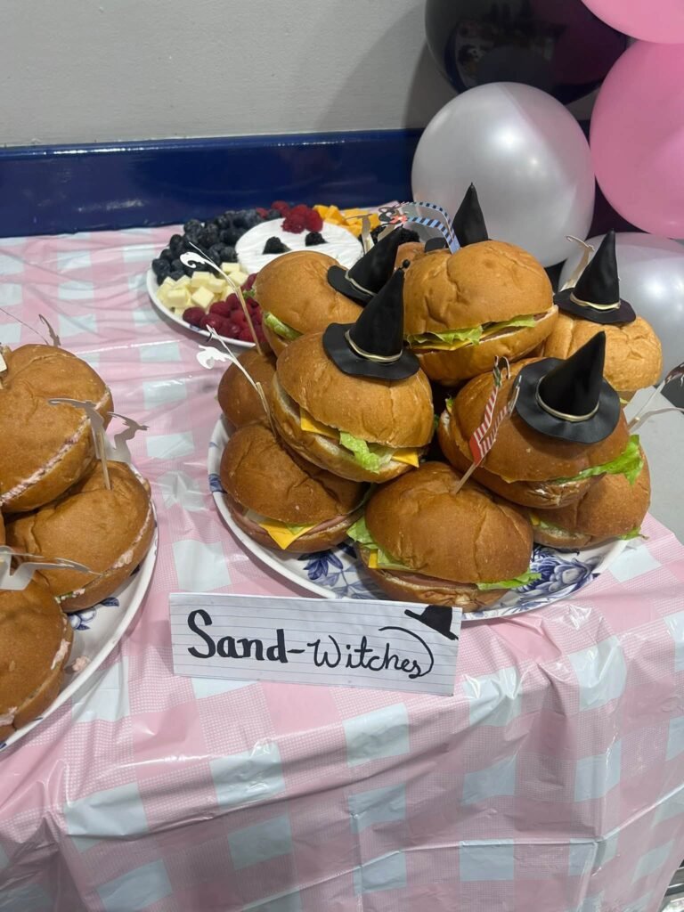 Close up of Sand-witches with black witch hats on a plate
