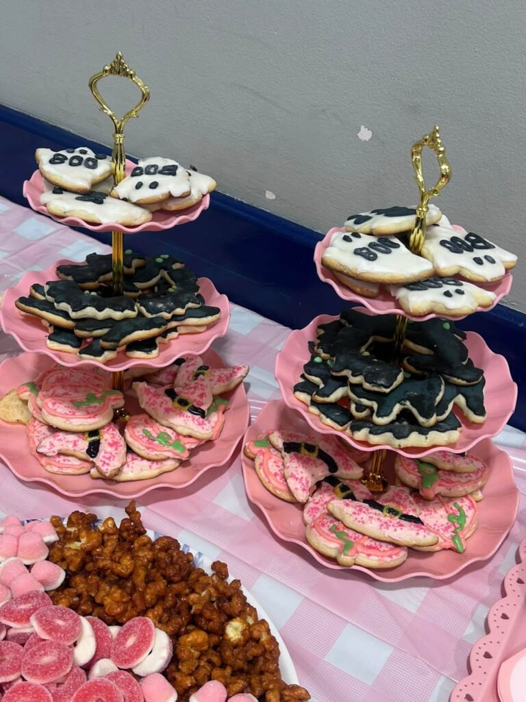 Ghost cookies on pink tiered stands at a baby shower