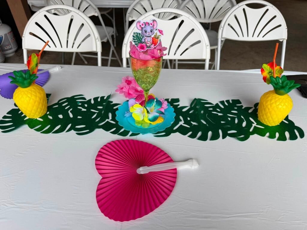 Pineapple cups, a tiki drink centerpiece and a pink paper fan