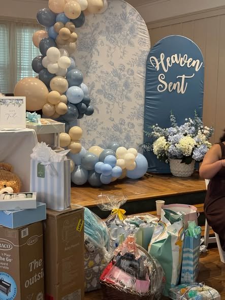 Heaven Sent baby shower backdrop with a blue toile arch and blue and white balloons