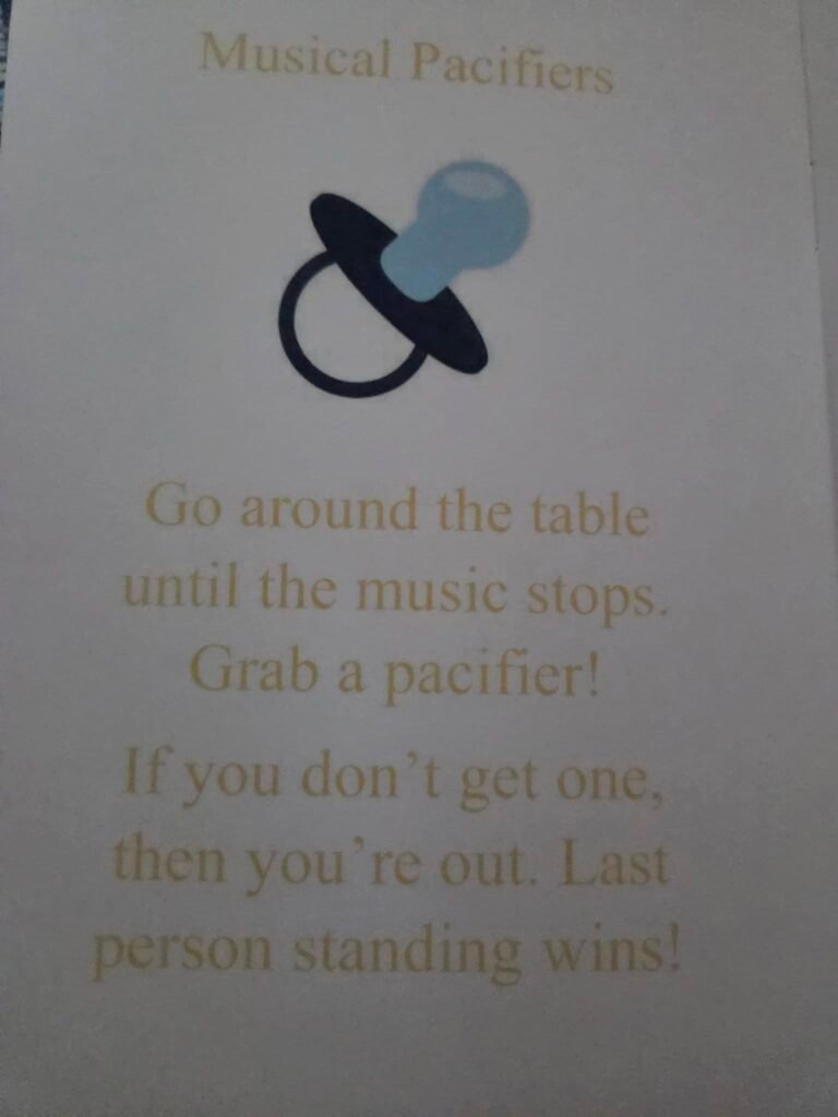 Musical pacifier game sign with a blue pacifier picture