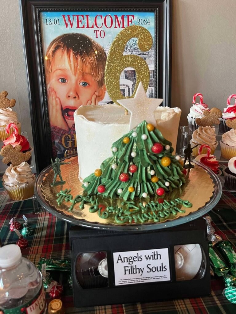 Christmas tree birthday cake with a number 6 topper on a VHS tape stand