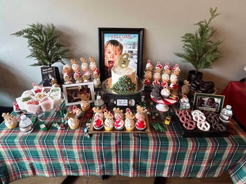 Home Alone snack table with a red plaid cloth and a framed poster