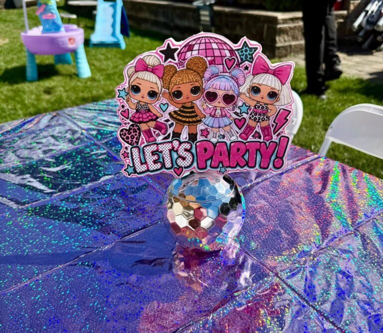 Disco ball centerpiece with a Let's Party topper on a shiny table