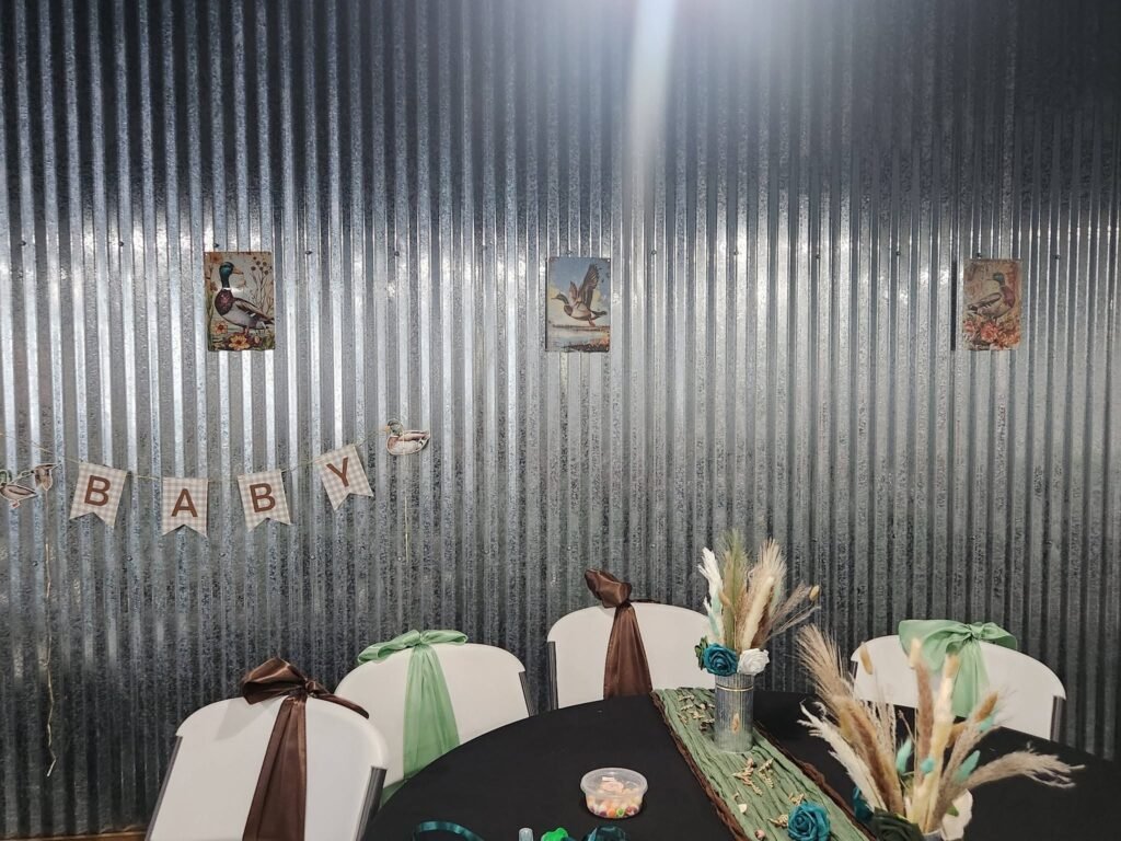 BABY letter banner on a metal wall over a round table