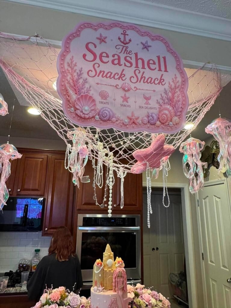 Seashell Snack Shack sign hanging over a kitchen with fish net