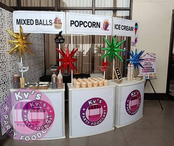 Mixed balls, popcorn and ice cream stations with starburst balloons