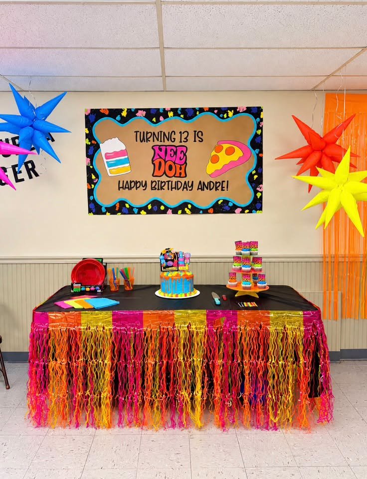 Nee Doh birthday table with a neon fringe skirt, star lanterns and a Turning 13 banner