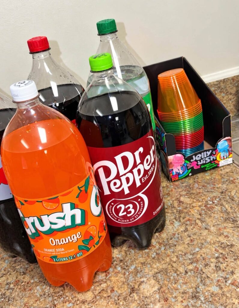 Drink corner with orange soda, Dr Pepper and neon cups