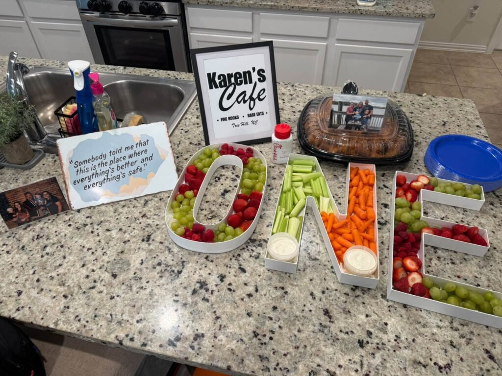 Fruit and veggie tray shaped like the word ONE