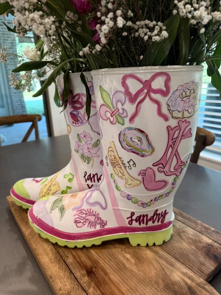Close up of a hand painted rain boot with bows, crawfish and the birthday name