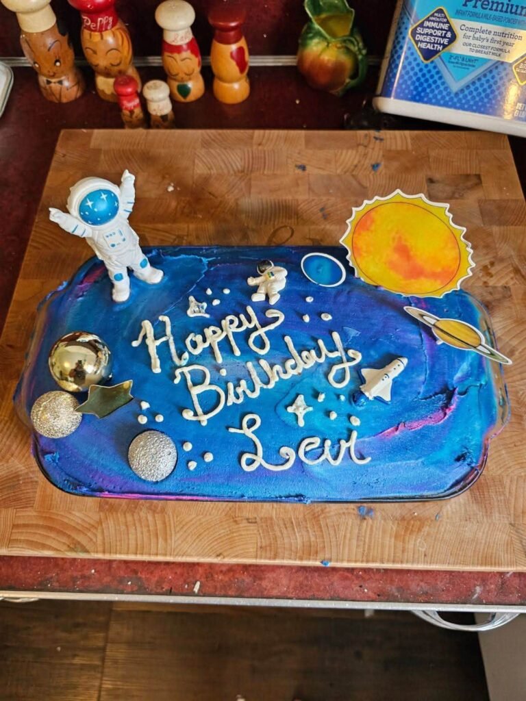 Space sheet cake with planets and a Happy Birthday message