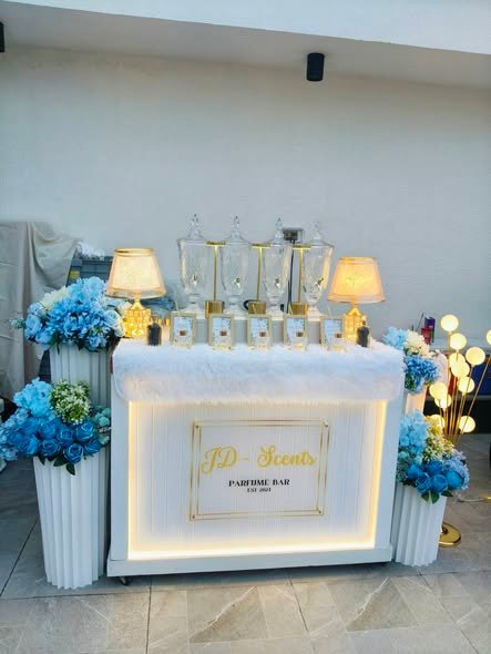 Perfume bar with blue hydrangea columns and LED branch lights