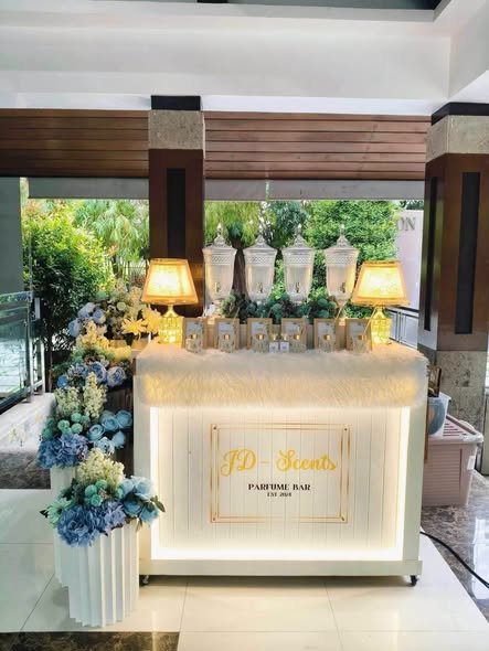 Perfume bar with blue flowers and lamps in a hotel lobby