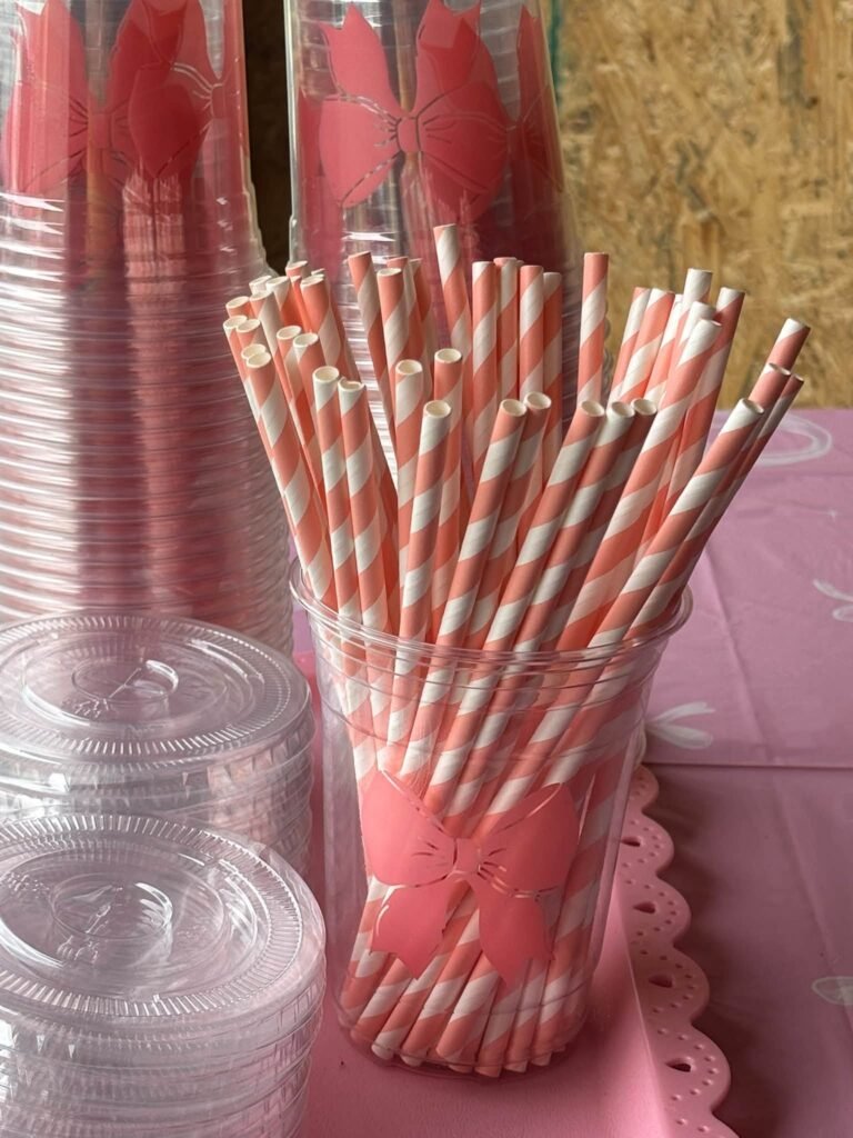 Pink striped paper straws in a clear cup