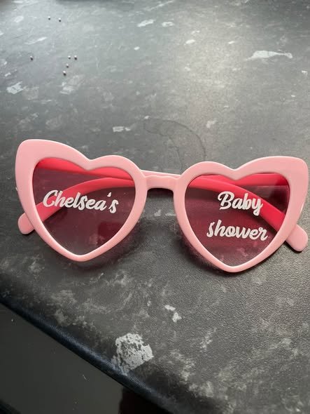 Pink heart sunglasses printed with the mom to be name and baby shower